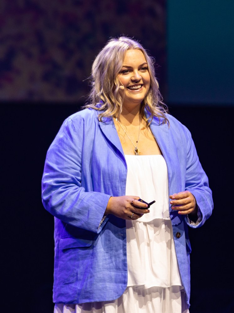 Molly Croft speaking on stage